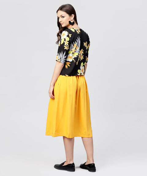 Black printed half sleeve tops with yellow calf length skirt with belt