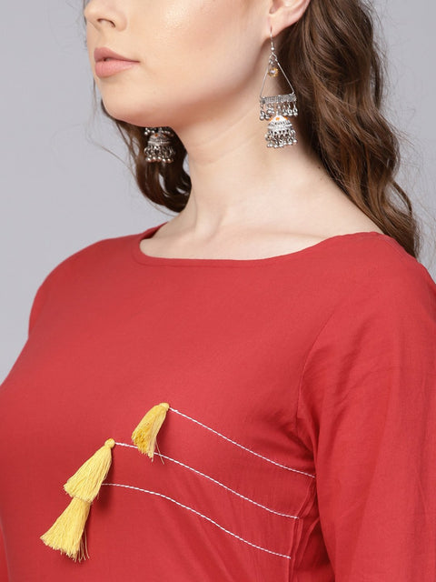 Solid red kurta with thread stitch and tassels detailing with a round neck and 3/4th sleeves