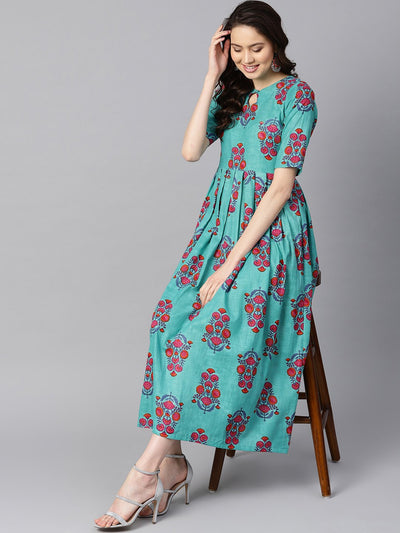 Turqish blue color printed half sleeve pleated maxi dress with deep back and tassel detailing.
