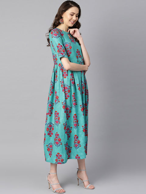 Turqish blue color printed half sleeve pleated maxi dress with deep back and tassel detailing.